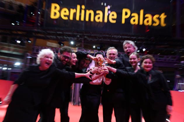 February 21, 2026, Berlin, Germany: Ilker Catak, with cast and crew pose with the Golden Bear for Best Film for Gelbe Briefe (Yellow Letters) after the closing ceremony of the 76th Berlin International Film Festival (Berlinale), Europe s first major film festival of the year, in Berlin. The festival runs from February 12 to 22, 2026. Berlin Germany  - ZUMAf146 20260221_zip_f146_007 Copyright: xRouzbehxFouladix