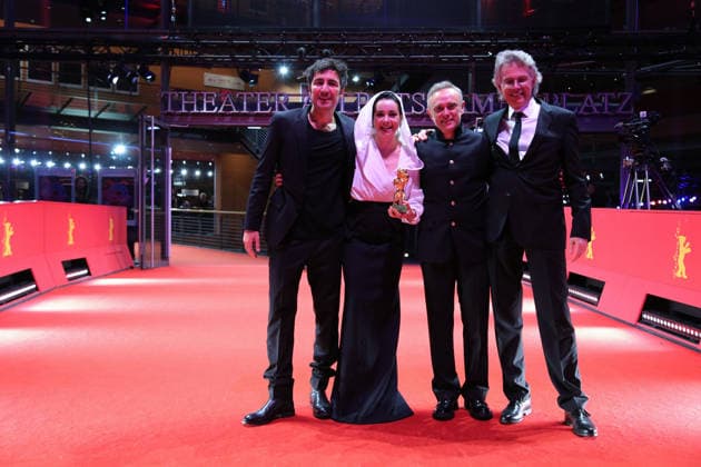 February 21, 2026, Berlin, Germany: Ilker Catak, with cast and crew pose with the Golden Bear for Best Film for Gelbe Briefe (Yellow Letters) after the closing ceremony of the 76th Berlin International Film Festival (Berlinale), Europe s first major film festival of the year, in Berlin. The festival runs from February 12 to 22, 2026. Berlin Germany  - ZUMAf146 20260221_zip_f146_008 Copyright: xRouzbehxFouladix
