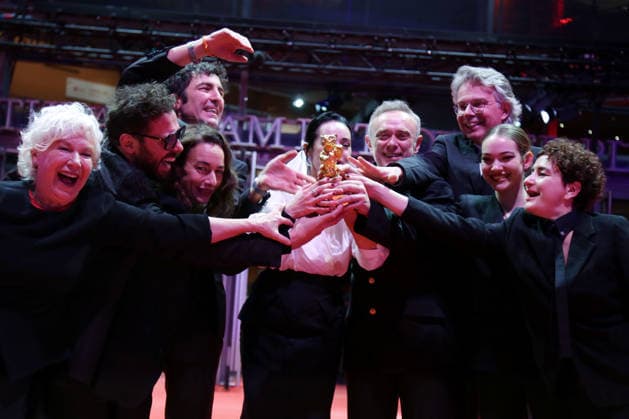 February 21, 2026, Berlin, Germany: Ilker Catak, with cast and crew pose with the Golden Bear for Best Film for Gelbe Briefe (Yellow Letters) after the closing ceremony of the 76th Berlin International Film Festival (Berlinale), Europe s first major film festival of the year, in Berlin. The festival runs from February 12 to 22, 2026. Berlin Germany - ZUMAf146 20260221_zip_f146_009 Copyright: xRouzbehxFouladix