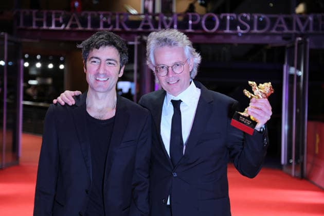 February 21, 2026, Berlin, Germany: German film director and screenwriter Ilker Catak (L) and Movie producer Ingo Fliess pose with the Golden Bear for Best Film for Gelbe Briefe (Yellow Letters) after the closing ceremony of the 76th Berlin International Film Festival (Berlinale), Europe s first major film festival of the year, in Berlin. The festival runs from February 12 to 22, 2026. Berlin Germany  - ZUMAf146 20260221_zip_f146_014 Copyright: xRouzbehxFouladix