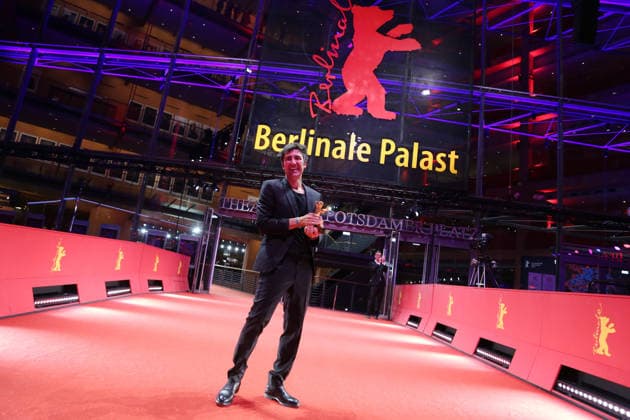 February 21, 2026, Berlin, Germany: German film director and screenwriter Ilker Catak poses with the Golden Bear for Best Film for Gelbe Briefe (Yellow Letters) after the closing ceremony of the 76th Berlin International Film Festival (Berlinale), Europe s first major film festival of the year, in Berlin. The festival runs from February 12 to 22, 2026. Berlin Germany - ZUMAf146 20260221_zip_f146_012 Copyright: xRouzbehxFouladix