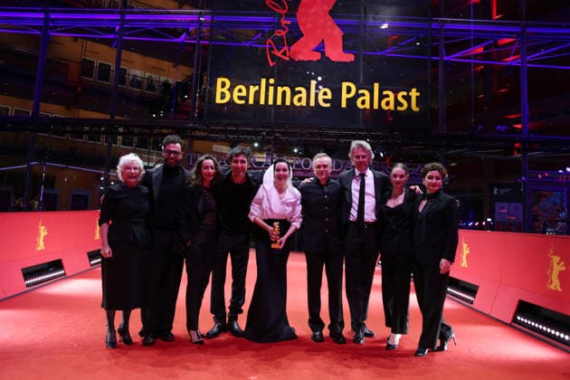 February 21, 2026, Berlin, Germany: Ilker Catak, with cast and crew pose with the Golden Bear for Best Film for Gelbe Briefe (Yellow Letters) after the closing ceremony of the 76th Berlin International Film Festival (Berlinale), Europe s first major film festival of the year, in Berlin. The festival runs from February 12 to 22, 2026. Berlin Germany  - ZUMAf146 20260221_zip_f146_017 Copyright: xRouzbehxFouladix