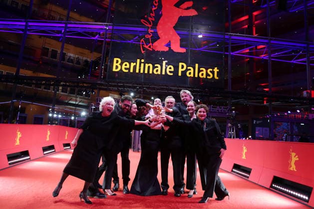 February 21, 2026, Berlin, Germany: Ilker Catak, with cast and crew pose with the Golden Bear for Best Film for Gelbe Briefe (Yellow Letters) after the closing ceremony of the 76th Berlin International Film Festival (Berlinale), Europe s first major film festival of the year, in Berlin. The festival runs from February 12 to 22, 2026. Berlin Germany  - ZUMAf146 20260221_zip_f146_019 Copyright: xRouzbehxFouladix