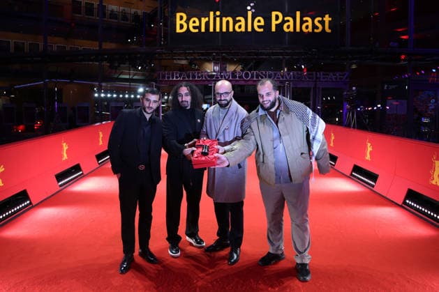 February 21, 2026, Berlin, Germany: Director Abdallah Alkhatib (C-L) and Producer Taqiyeddine Issaad (C-R) pose with the GWFF Best Feature Film Debut Award for Chronicles From the Siege after the closing ceremony of the 76th Berlin International Film Festival (Berlinale), Europe s first major film festival of the year, in Berlin. The festival runs from February 12 to 22, 2026. Berlin Germany  - ZUMAf146 20260221_zip_f146_043 Copyright: xRouzbehxFouladix