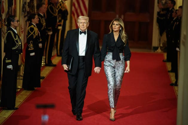 U.S. President Donald Trump and First Lady Melania Trump walk down the Cross Hall as they arrive for the Governors Dinner in the East Room of the White House on Saturday, February 21, 2026 in Washington, DC.  WAX20260221230 SamuelxCorum