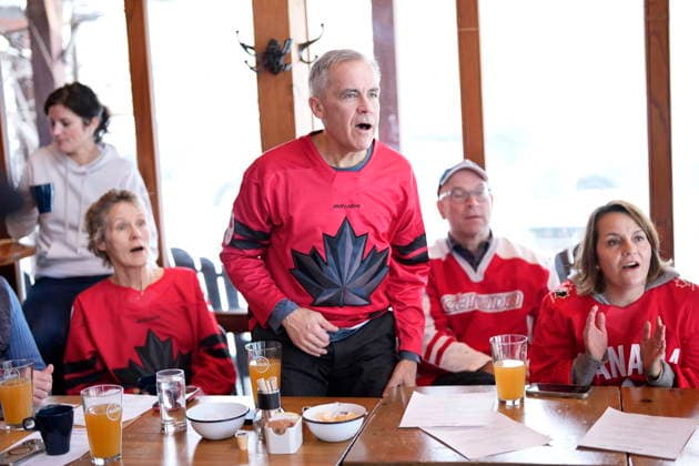 February 22, 2026, Chelsea, Pq, CAN: Prime Minister Mark Carney reacts to a chance for Canada as he watches the gold medal men s ice hockey game against the United States at the 2026 Milan Cortina Winter Olympics, at a pub in Chelsea, Que., on Sunday, Feb. 22, 2026. Chelsea CAN  - ZUMAc35_ 20260222_zaf_c35_035 Copyright: xJustinxTangx