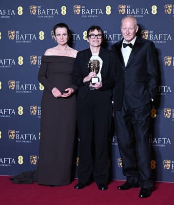 British actress Emily Watson, film producer Clare Binns and Swedish actor Stellan Skarsgard attend the Winners Room at the EE BAFTA Film Awards at the Royal Festival Hall in London, England on Sunday, February 22, 2026.  LON202602221112 RUNExHELLESTAD
