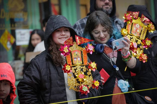 (260223) -- VANCOUVER, Feb. 23, 2026 -- People carry Chinese New Year-themed ornaments while watching a Spring Festival parade at Chinatown in Vancouver, British Columbia, Canada, on Feb. 22, 2026. The 52nd annual Vancouver Chinatown Spring Festival Parade was held here on Sunday to celebrate the Chinese Year of the Horse. (Photo by Xinhua) CANADA-VANCOUVER-SPRING FESTIVAL PARADE LiangxSen 
