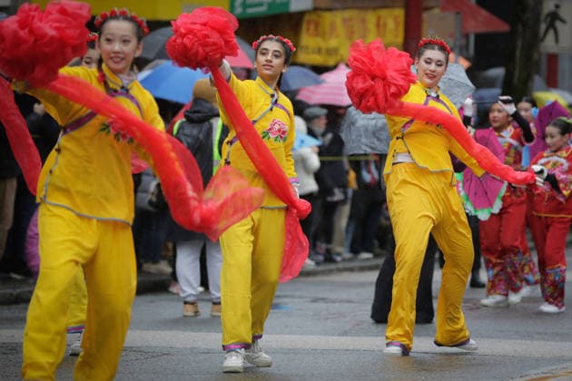 (260223) -- VANCOUVER, Feb. 23, 2026 -- Dancers perform along the street during a Spring Festival parade at Chinatown in Vancouver, British Columbia, Canada, on Feb. 22, 2026. The 52nd annual Vancouver Chinatown Spring Festival Parade was held here on Sunday to celebrate the Chinese Year of the Horse. (Photo by Xinhua) CANADA-VANCOUVER-SPRING FESTIVAL PARADE LiangxSen 
