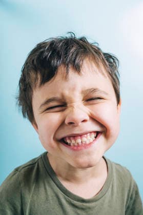 Portrait of smiling child in green shirt looking at camera model released, Symbolfoto, ANAF05520