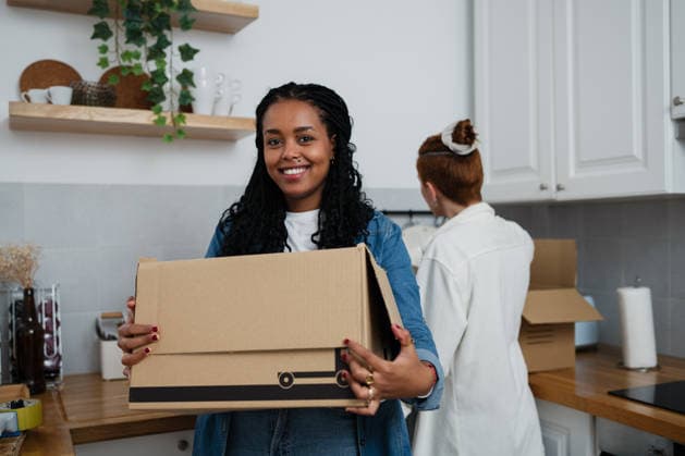 Smiling couple unpacking boxes in kitchen during move model released, Symbolfoto property released, ATSF00190
