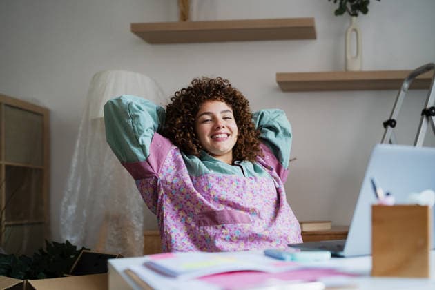 Smiling woman relaxing on break at home during remote work model released, Symbolfoto property released, ATSF00246