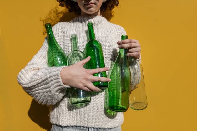 Child holding glass bottles showing sustainability and recycling model released, Symbolfoto, Mainz RLP Germany ALPF00003