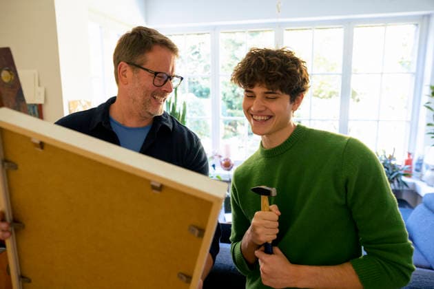 Father and son bonding at home while hanging a picture frame model released, Symbolfoto property released, KNSF10674