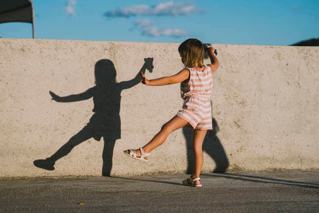 Child playing with shadow and dancing outdoors in sunlight model released, Symbolfoto, NDEF03212