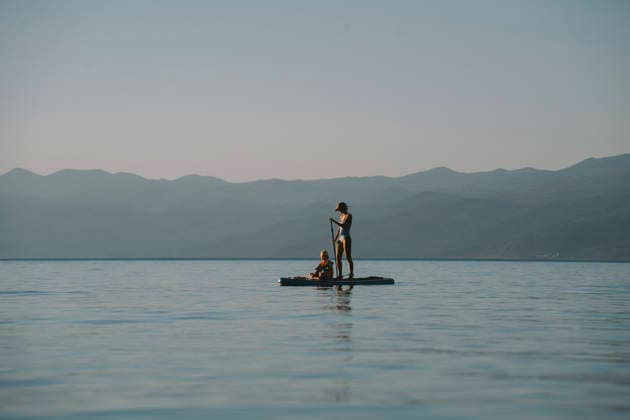 Family paddling on paddleboard against tranquil seascape in summer model released, Symbolfoto, NDEF03221