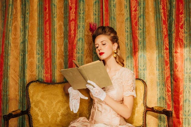 Elegant woman in rococo vintage dress reading a book indoors model released, Symbolfoto, VSNF04576
