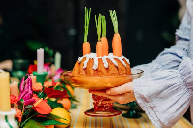 Decorated carrot cake held by woman at festive Easter family dinner model released, Symbolfoto property released, VSNF04620
