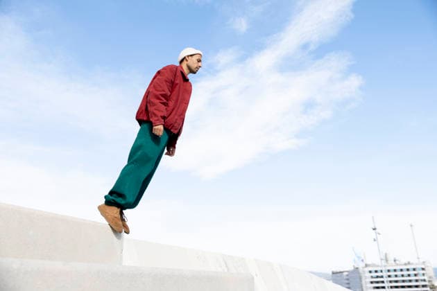 Man leaning forward performing parkour on urban steps in Barcelona model released, Symbolfoto, YPF00071