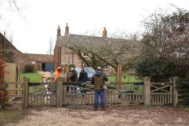 A press photographer watches as workers continues to install fencing around Marsh Farm. Marsh Farm is just along the road from Wood Farm on the Sandringham Estate where Andrew Mountbatten-Windsor is staying. Mountbatten-Windsor was arrested last week, and taken to Aylsham police station before being released under investigation, and returning to Wood Farm. Andrew Mountbatten-Windsor, formerly Prince Andrew The Duke of York, has previously denied any wrongdoing in relation to sex offender Jeffrey Epstein. Andrew Mountbatten-Windsor, Sandringham, Norfolk, on 25th February, 2026 