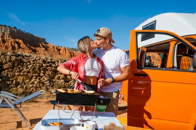 Couple enjoying a romantic cookout in Red Canyon Spain A couple shares a loving moment while cooking outdoors with a scenic view of Red Canyon, Spain in the background. An expression of love and adventure in a picturesque setting. Model Released JoseLuisCarrascosa_ID32450_1105872_185 Copyright: xJosexLuisxCarrascosax