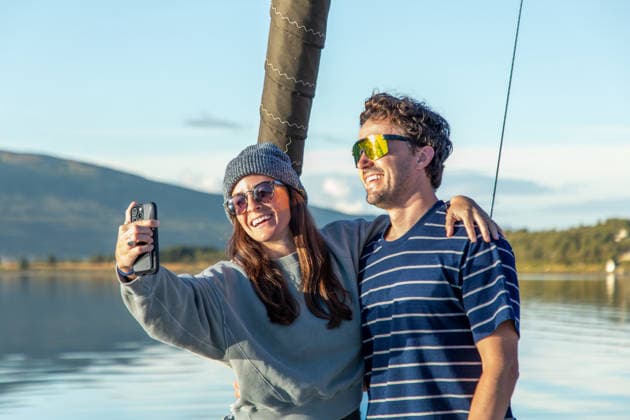 Couple enjoying a serene boat ride in scenic Norway A couple enjoys a leisurely boat ride in Norway, capturing moments with smiles and scenic beauty. The serene waters and stunning landscape highlight a perfect day outdoors. Model Released Robcabphotography_ID33004_1123765_034 Copyright: xRobcabphotographyx RECORD DATE NOT STATED
