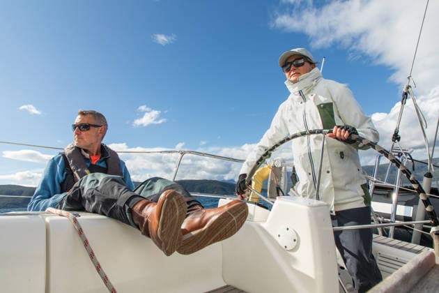 Couple sailing adventure in scenic Norwegian waters A couple navigates the serene waters of Norway aboard a sailboat, enjoying the adventure and tranquility of the open sea under a clear blue sky and scenic surroundings. Model Released Robcabphotography_ID33062_1125393_052 Copyright: xRobcabphotographyx RECORD DATE NOT STATED