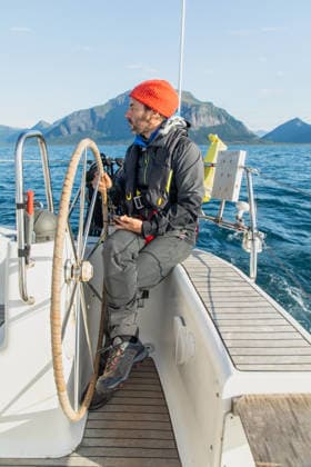 Adventure sailing in Norway s stunning fiords A sailor navigates a boat through Norway s breathtaking fiords, surrounded by majestic mountains and serene waters. Experience the beauty of Lofoten s natural landscape. Model Released Robcabphotography_ID33103_1126557_031 Copyright: xRobcabphotographyx RECORD DATE NOT STATED