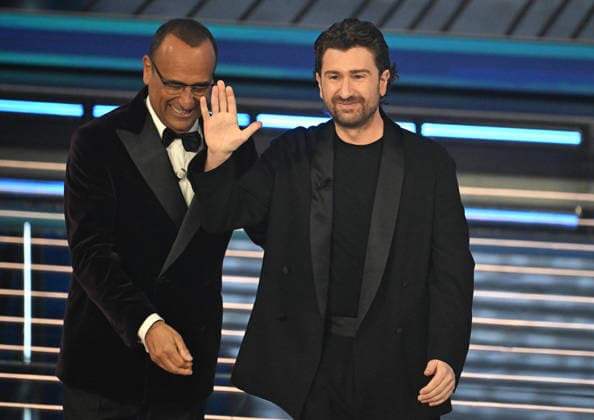 February 27, 2026, Sanremo, ITALY: Sanremo Festival host and artistic director Carlo Conti (L) with Italian actor Alessandro Siani on stage at the Ariston theatre during the 76th edition of the Sanremo Italian Song Festival, in Sanremo, Italy, 27 February 2026. The music festival will run from 24 to 28 February 2026. ANSA RICCARDO ANTIMIANI Sanremo ITALY  - ZUMAa110 20260227_zaf_a110_123 Copyright: xRiccardoxAntimianix