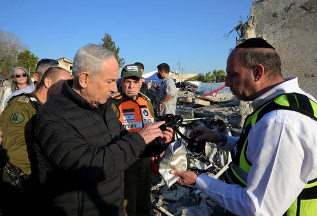 March 2, 2026, Bet Shemesh, Israel: Israeli Prime Minister BENJAMIN NETANYAHU (L) surveys the catastrophic damage at a residential site in Bet Shemesh following a direct hit from an Iranian ballistic missile. The strike, which occurred on Sunday, March 1, 2026, resulted in the deaths of nine civilians, including three siblings; Yaakov, 16, Avigail, 15, and Sarah Biton, 13. The missile directly impacted a public bomb shelter causing a total structural collapse that emergency responders described as the deadliest single incident within Israel since the start of Operation Roaring Lion. At least 28 others were injured in the blast, which leveled nearby homes and a public building. Bet Shemesh Israel  - ZUMAi99_ 20260302_zip_i99_001 Copyright: xAvixOhayon IsraelxGpox