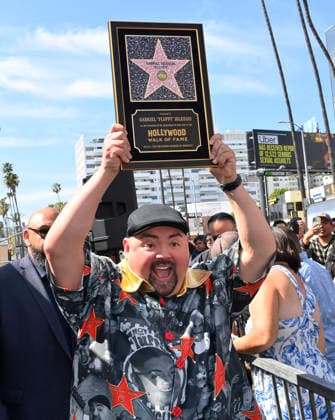 Comedian Gabriel Fluffy Iglesias holds up a replica plaque during unveiling ceremony honoring him with the 2,838th star on the Hollywood Walk of Fame in Los Angeles on Tuesday, March 3, 2026.  LAP2026030304 JIMxRUYMEN