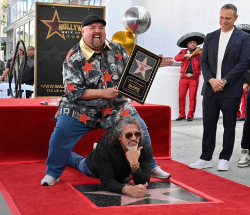 Comedian Gabriel Fluffy Iglesias holds a replica plaque as he is joined by Martin Moreno during unveiling ceremony honoring him with the 2,838th star on the Hollywood Walk of Fame in Los Angeles on Tuesday, March 3, 2026.  LAP2026030317 JIMxRUYMEN