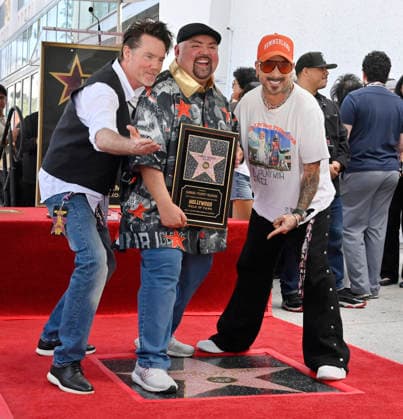 Comedian Gabriel Fluffy Iglesias holds a replica plaque as he is joined by Mike Becker (L) and AJ McLean during unveiling ceremony honoring him with the 2,838th star on the Hollywood Walk of Fame in Los Angeles on Tuesday, March 3, 2026.  LAP2026030320 JIMxRUYMEN