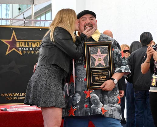 Comedian Gabriel Fluffy Iglesias holds a replica plaque as he is joined by his partner Tiffany Kate during unveiling ceremony honoring him with the 2,838th star on the Hollywood Walk of Fame in Los Angeles on Tuesday, March 3, 2026.  LAP2026030323 JIMxRUYMEN