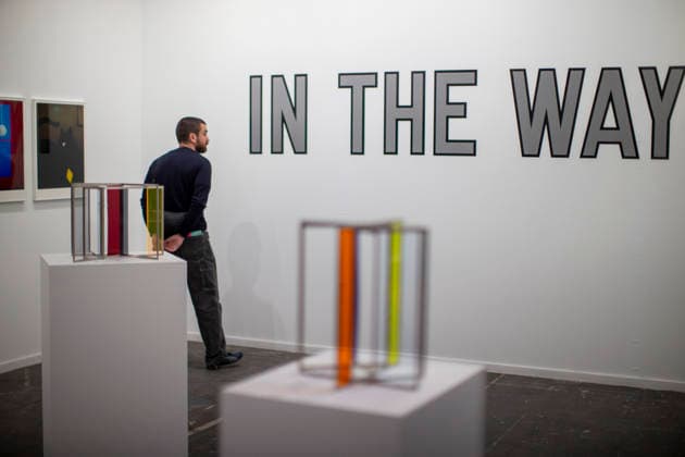 March 4, 2026, Madrid, Madrid, Spain: A visitor observes the work of Lawrence Weiner during the opening of ARCO (Spain s International Contemporary Art Fair) at its 45th edition at the IFEMA exhibition center in Madrid. Madrid Spain  - ZUMAs296 20260304_znp_s296_012 Copyright: xLuisxSotox