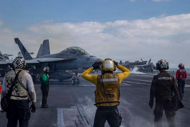 March 4, 2026, Undisclosed Location, United States: A U.S. Navy F A-18F Super Hornet, with the Black Aces of Strike Fighter Squadron 41, is signaled to position for launch from the flight deck of the Nimitz-class aircraft carrier USS Abraham Lincoln during Operation Epic Fury, March 3, 2026, from an undisclosed location. The United States and Israel launched joint strikes on Iran. Undisclosed Location United States - ZUMAp138 20260304_zaa_p138_032 Copyright: xUsxNavy U.S.xNavyx