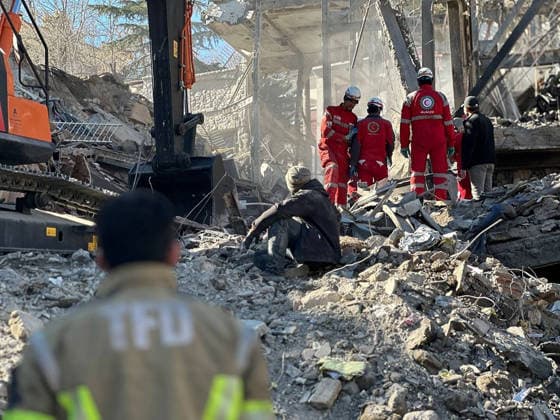 Members of Iranian rescue teams search through the rubble for victims after a building was struck by U.S.-Israeli airstrikes in Tehran, Iran on Wednesday, March 4, 2026. The Islamic Revolutionary Guard Corps said on March 4 that it has full control over the Strait of Hormuz, a vital waterway for global energy transit.  IRN2026030463 IranianxRedxCrescent