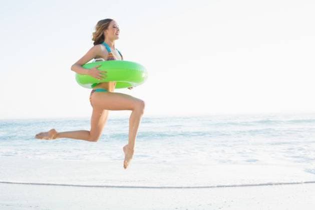 Beautiful young woman holding a rubber ring Beautiful young woman holding a rubber ring jumping on the beach, model released, Cape Town, South Africa, 11.07.2013, 222006.jpg, fit, toned, healthy, fitness, health, physical, shape, sporty, athletic, slim, slender, body, attractive, pretty, beautiful, wellness, body care, striped, bikini, beachwear, swimwear, fair hair, blonde, long hair, curly hair, natural, active, leisure, lifestyle, coastline, shore, summertime, holidays, ocean, sea, beach, waves, water, sunny, bright, vacation, sand, jumping, leaping, jump, happy, smiling, cheerful, rubber ring, green, holding, wearing, joy, freedom, escape, escapism Young Adult, Woman, Female, Caucasian, 18-19 Years, Young Women, Caucasian Ethnicity Ou