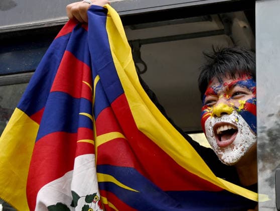 NEW DELHI, INDIA - MARCH 10: An activist from the Tibetan Youth Congress (TYC) shout slogans as they are detained in Police bus during their protest outside the Chinese Embassy in Chanakyapuri to commemorate the 67th anniversary of the Tibetan National Uprising Day on March 10, 2026 in New Delhi, India. The demonstration saw protesters scaling police barricades and raising slogans of Free Tibet and China out of Tibet before security forces intervened.(Photo by Ishant Chauhan Hindustan Times) Tibetan Youth Congress Stages Protest Outside Chinese Embassy On 67th Tibetan National Uprising Day