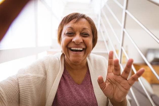 Cheerful african american senior woman waving hand during video call by railing at home Cheerful african american senior woman waving hand during video call by railing at home. lifestyle and communication., model released, , property released, Cape Town, South Africa, 07.10.2021, 3086276.jpg, people,cheerful,african american,senior woman,waving hand,video call,railing,home,lifestyle,communication,young,happy,person,internet,adult,happiness,smiling,smile,attractive,house,portrait,leisure,fun,computer,casual,technology,indoors,room,online,african,american,senior,woman,waving,hand,video,call Mature Adult,Woman,Female,Mixed-Race