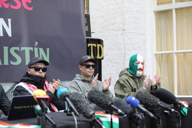 Kneecap s member hold a press conference in Belfast BELFAST, NORTHERN IRELAND - MARCH 11: Kneecap s Mo Chara, Muhllai Bap, DJ Provai hold a press conference at Conway Mill in Belfast, Northern Ireland on March 11, 2026. The UK government lost its appeal over a judge s decision to dismiss terror charges against Liam Og O hAnnaidh, known as Mo Chara related to allegedly displaying a Hezbollah flag at a concert in London in November 2024. The High Court delivered its judgment in an appeal brought by the Director of Public Prosecutions (DPP) challenging the magistrates’ court ruling that dismissed the case against the band member. Conor Mccaughley Anadolu Belfast Ireland. Editorial use only. Please get in touch for any other usage.  Copyright: x2026xAnadoluxConorxMccaughleyx