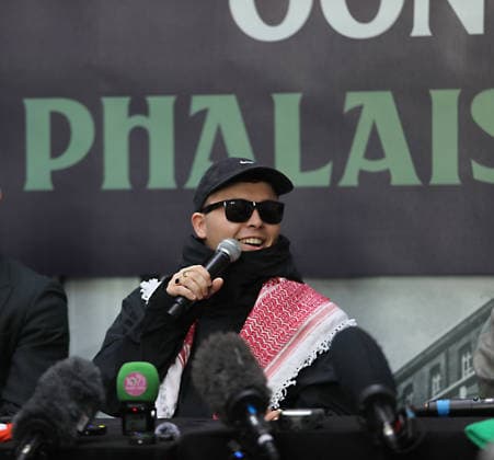 Kneecap s member hold a press conference in Belfast BELFAST, NORTHERN IRELAND - MARCH 11: Kneecap s Mo Chara, Muhllai Bap, DJ Provai hold a press conference at Conway Mill in Belfast, Northern Ireland on March 11, 2026. The UK government lost its appeal over a judge s decision to dismiss terror charges against Liam Og O hAnnaidh, known as Mo Chara related to allegedly displaying a Hezbollah flag at a concert in London in November 2024. The High Court delivered its judgment in an appeal brought by the Director of Public Prosecutions (DPP) challenging the magistrates’ court ruling that dismissed the case against the band member. Conor Mccaughley Anadolu Belfast Ireland. Editorial use only. Please get in touch for any other usage.  Copyright: x2026xAnadoluxConorxMccaughleyx