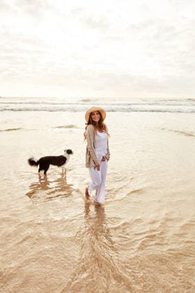 Ocean water, thinking and woman with dog on holiday for adventure, trip and happiness with companion. Person, smile and pet at beach for summer vacation, travel and reflection with border collie. model released property released Copyright: xx