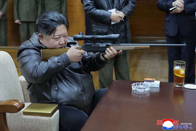 This image, released on March 12, 2026, by the North Korean Official News Service (KCNA), shows North Korean leader Kim Jong Un and his daughter, Kim Ju Ae, visiting a munitions factory. The father-daughter duo toured the facility before test-firing pistols.  WAX2026031201 KCNA