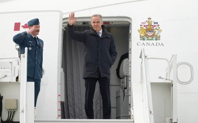 March 12, 2026, Ottawa, On, Canada: Prime Minister Mark Carney waves as he boards a government plane in Ottawa, Thursday, March 12, 2026. Ottawa Canada  - ZUMAc35_ 20260312_zaf_c35_026 Copyright: xAdrianxWyldx