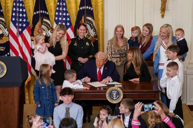 First Lady Melania Trump, right, watches as President Donald Trump displays a signed proclamation during a Women s History Month event in the East Room of the White House in Washington, DC, US, on Thursday, March 12, 2026. Every year, March is designated Women s History Month by presidential proclamation.  WASP2026031209 ALxDRAGO