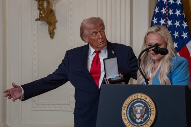 March 12, 2026, Washington, Dc, United States: US President DONALD TRUMP poses with US bobsledder KAILLIE ARMBRUSTER HUMPHRIES, who holds her two bronze medals from the Milano Cortina 2026 Winter Olympic Games, after presenting him with an Ikkos Award during a WomenÃ¢â‚¬â ¢s History Month event in the East Room of the White House in Washington, DC, on March 12, 2026. The Ikkos Award allows Team USA medalists to recognize individuals who supported them on their journey to the Olympic Games. Washington United States - ZUMAl312 20260312_znp_l312_027 Copyright: xAndrewxLeydenx