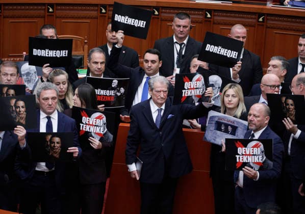 Albanian Parliament vote down a prosecution request to lift former Deputy Prime Minister Belinda Balluku, in Tirana, Albania, 12 March 2026. Albanian Democratic Party Leader, Sali Berisha (C), and opposition lawmakers hold signs as they block the podium during a parliamentary session in Tirana, Albania, on March 12, 2026. The Ruling Socialist Party uses its majority in parliament to vote down a prosecution request to lift former Deputy Prime Minister Belinda Balluku s immunity, allowing for her arrest. While the vote was taking place in parliament, opposition Democratic Party supporters protested outside. Light Studio Agency Malton Dibra TIRANE ALBANIA Copyright: xMaltonxDibrax
