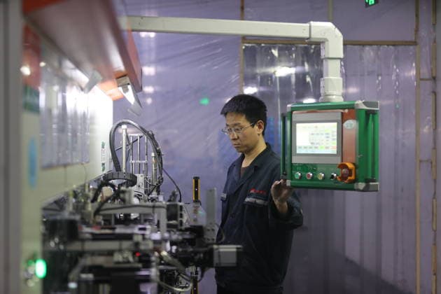 Lithium-ion Batteries Manufacturing in Sanmenxia SANMENXIA, CHINA - MARCH 12, 2026 - A worker in the production workshop of Henan Pude New Energy Technology Co., Ltd. is engaged in the production of lithium-ion batteries in Sanmenxia City, Henan Province, China on March 12, 2026. Sanmenxia Henan China  Copyright: xCFOTOx i1773416479108