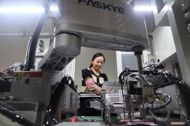 Lithium-ion Batteries Manufacturing in Sanmenxia SANMENXIA, CHINA - MARCH 12, 2026 - A worker in the production workshop of Henan Pude New Energy Technology Co., Ltd. is engaged in the production of lithium-ion batteries in Sanmenxia City, Henan Province, China on March 12, 2026. Sanmenxia Henan China  Copyright: xCFOTOx i1773416480433